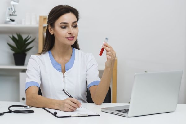 smiling-doctor-looking-blood-sample (1)
